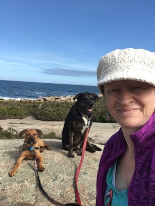 Woman and dogs in New England at pet friendly at Halibut Point State Park, MA