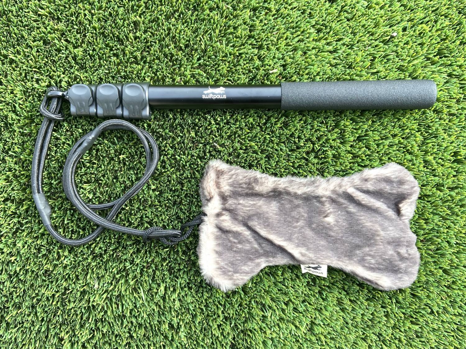 SwiftPaws Flirt Pole Review - pole and bone on grass